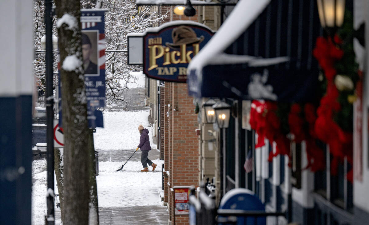 A person shovels along Allen Street on Tuesday, Dec. 2, 2025.