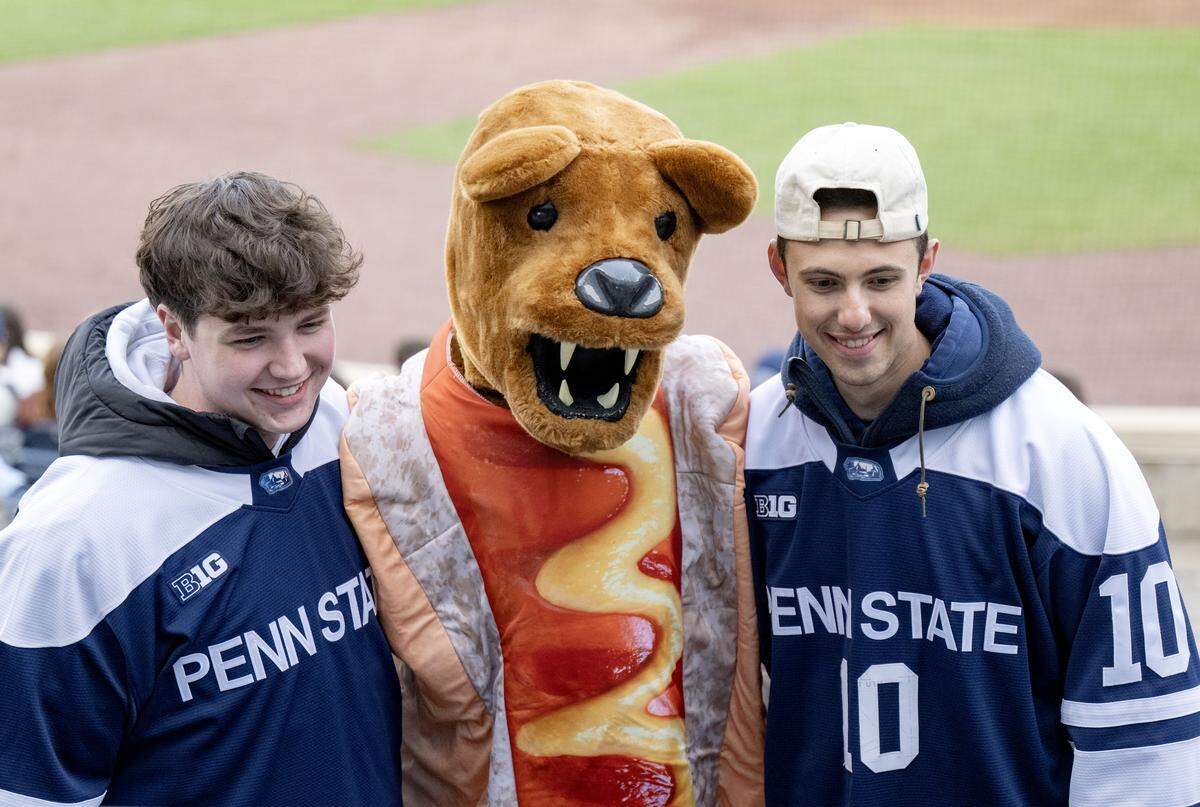 Wearing a hot dog costume, the Nittany Lion poses for a photo with fans at the Penn State baseball game against St. Bonaventure on Tuesday, March 24, 2026.  