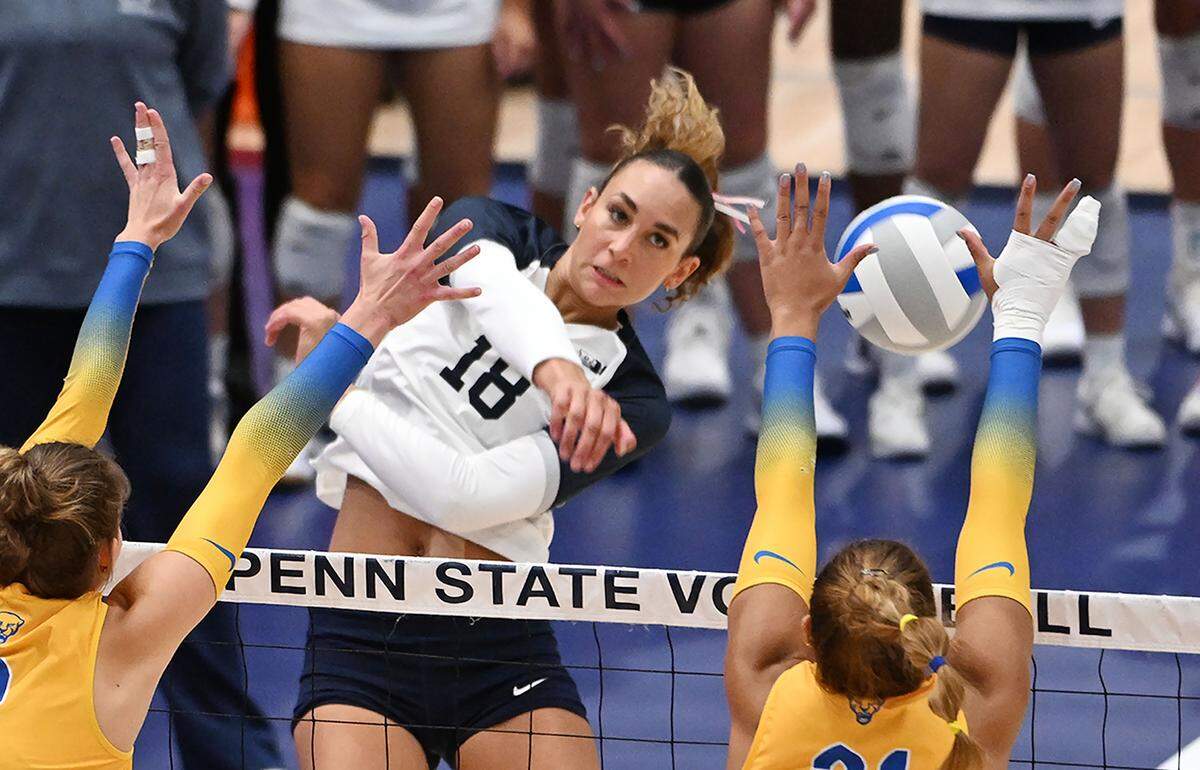 Penn State's Kennedy Martin (18) drives the ball into a Pitt defender during Wednesday's match against the Pitt Panthers at Rec Hall in State College. 