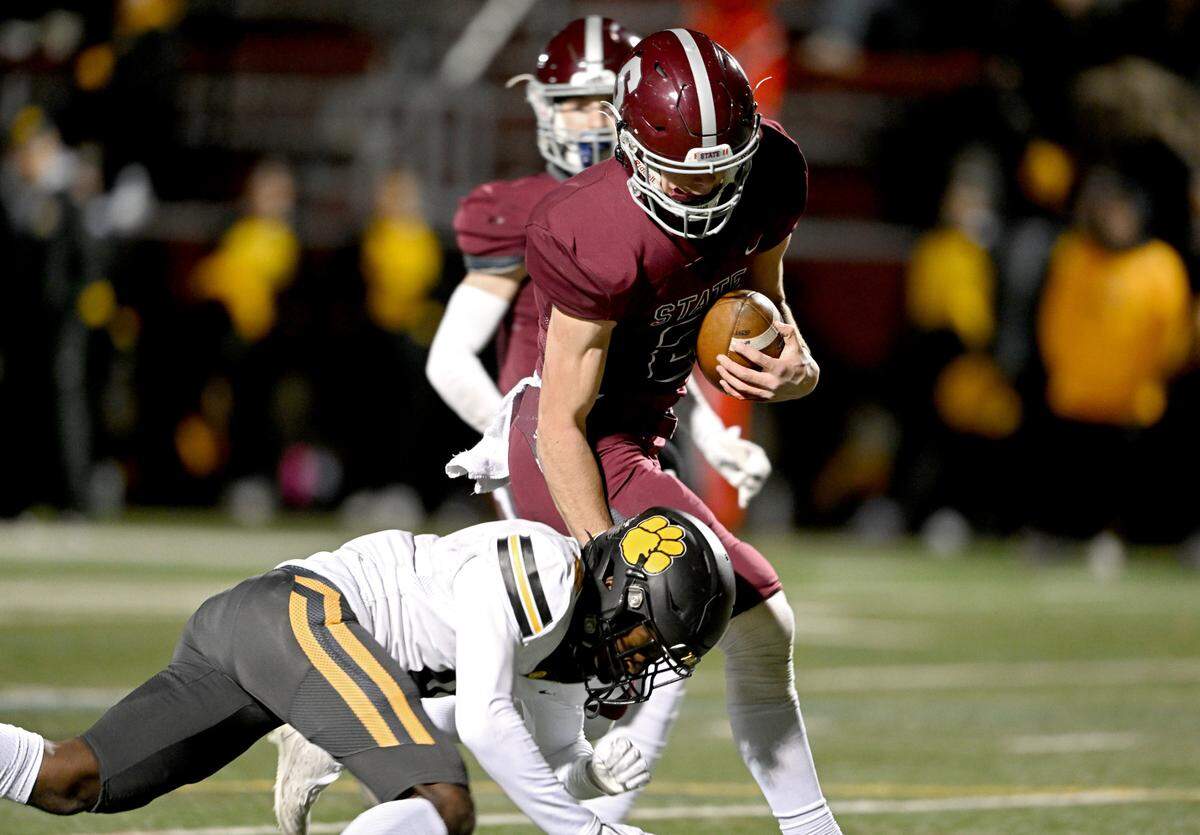 State College’s Finn Furmanek pushes past North Allegheny defenders for a touchdown during the PIAA class 6A quarterfinals game on Friday, Nov. 25, 2022 at Memorial Field.