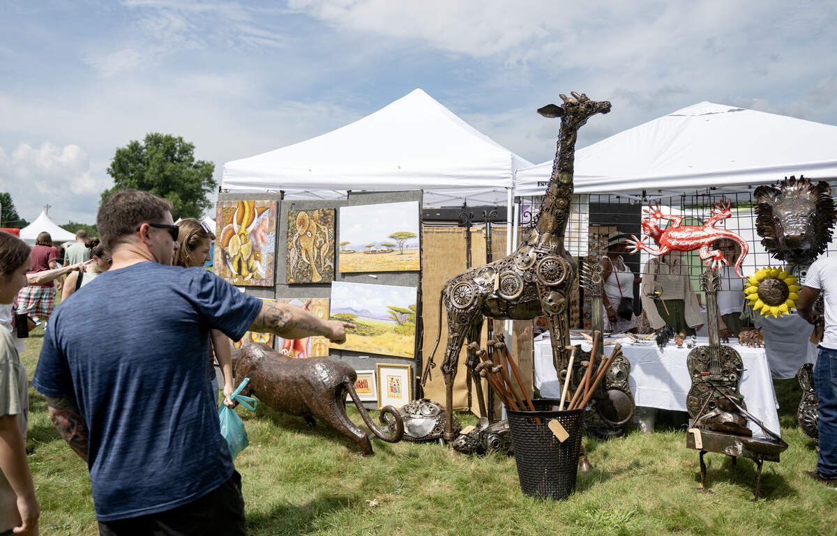 Visitors browse a booth at the People’s Choice Festival on Thursday, July 9, 2026.