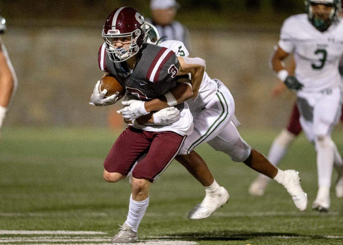 Central Dauphin’s Ayden Smith tries to stop State College’s Ty Salazer during the game on Friday, Sept. 23, 2022 at Memorial Field.
