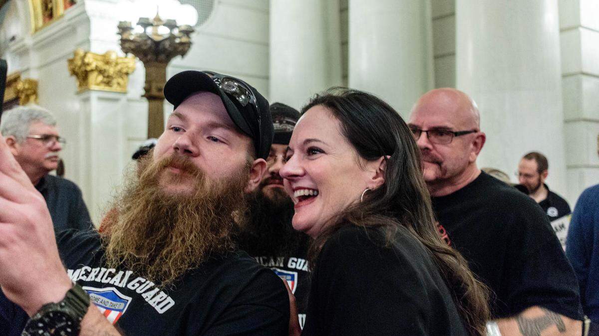 State Rep. Stephanie Borowicz, R-McElhattan, poses for a selfie with members of the white nationalist group American Guard at a gun rights rally in the Capitol building on Monday.