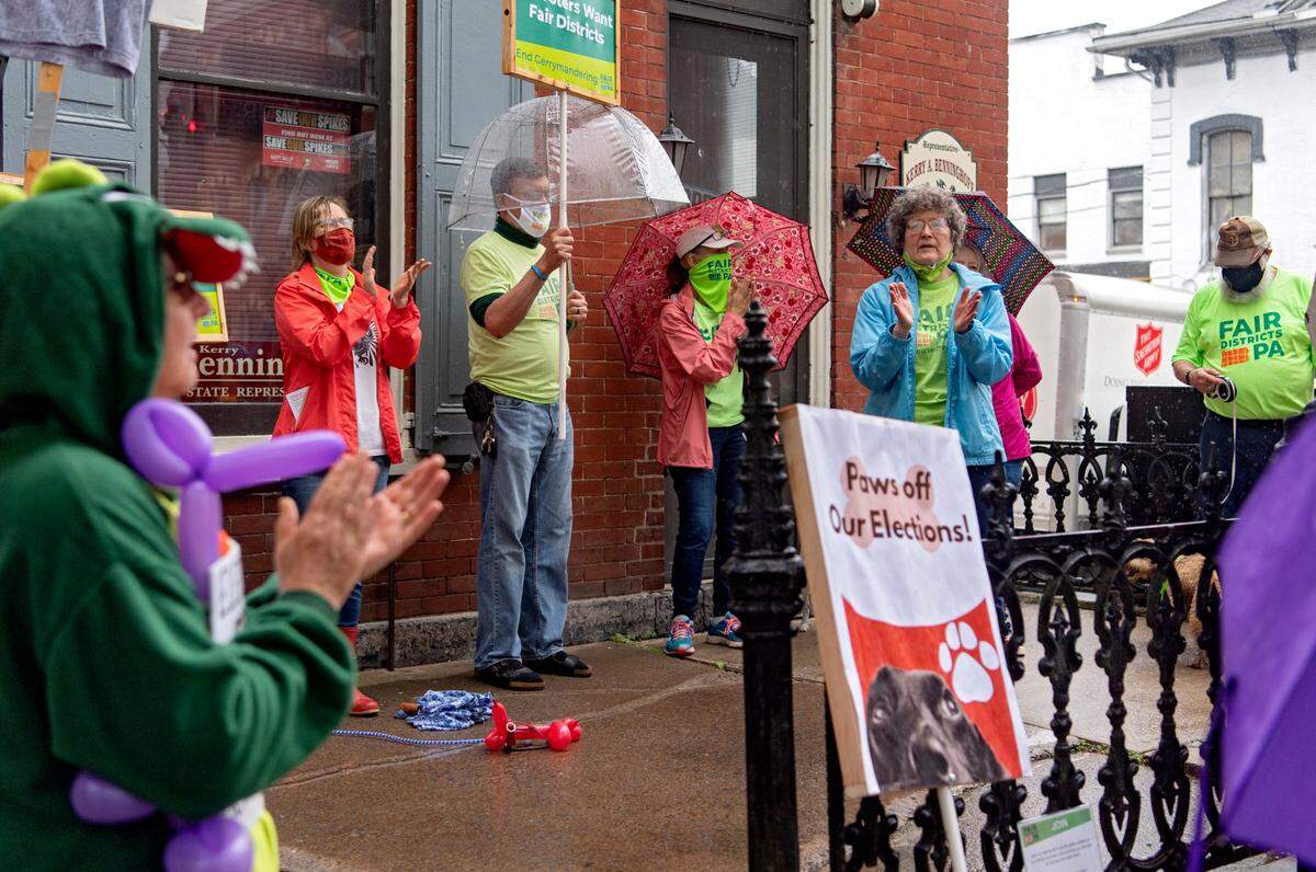 Members of Fair Districts Centre County chant outside of state Rep. Kerry Benninghoff’s office on Thursday as they hounded officials to end gerrymandering.