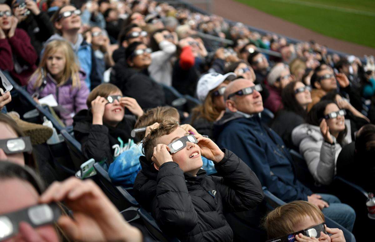 Thousands of people look up at the sky Monday hoping to see a glimpse of the solar eclipse through the clouds during SolarFest.