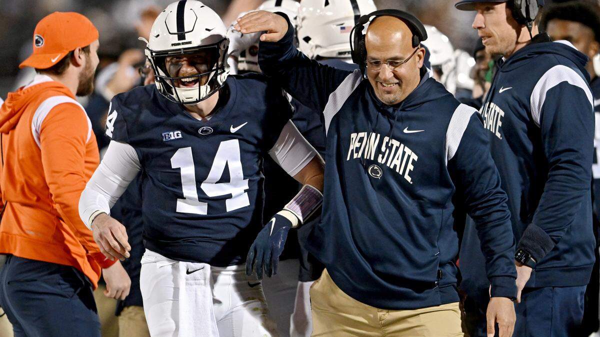 Penn State quarterback Sean Clifford and coach James Franklin celebrate a touchdown during the game on Saturday, Nov. 26, 2022.