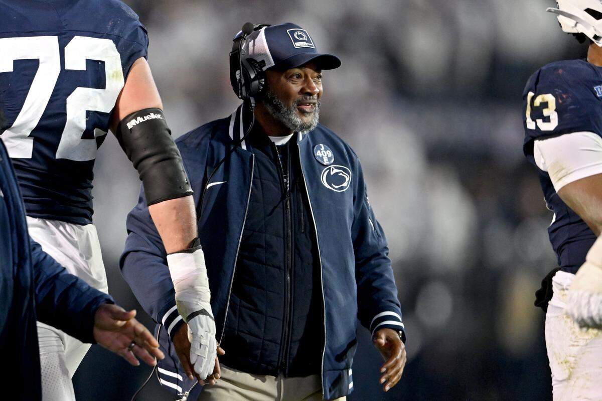 Penn State interim coach Terry Smith high-fives players after a play during the game against Nebraska on Saturday, Nov. 22, 2025, at Beaver Stadium. Smith wore a pin that said “409” and “Joe” to acknowledge Joe Paterno. 