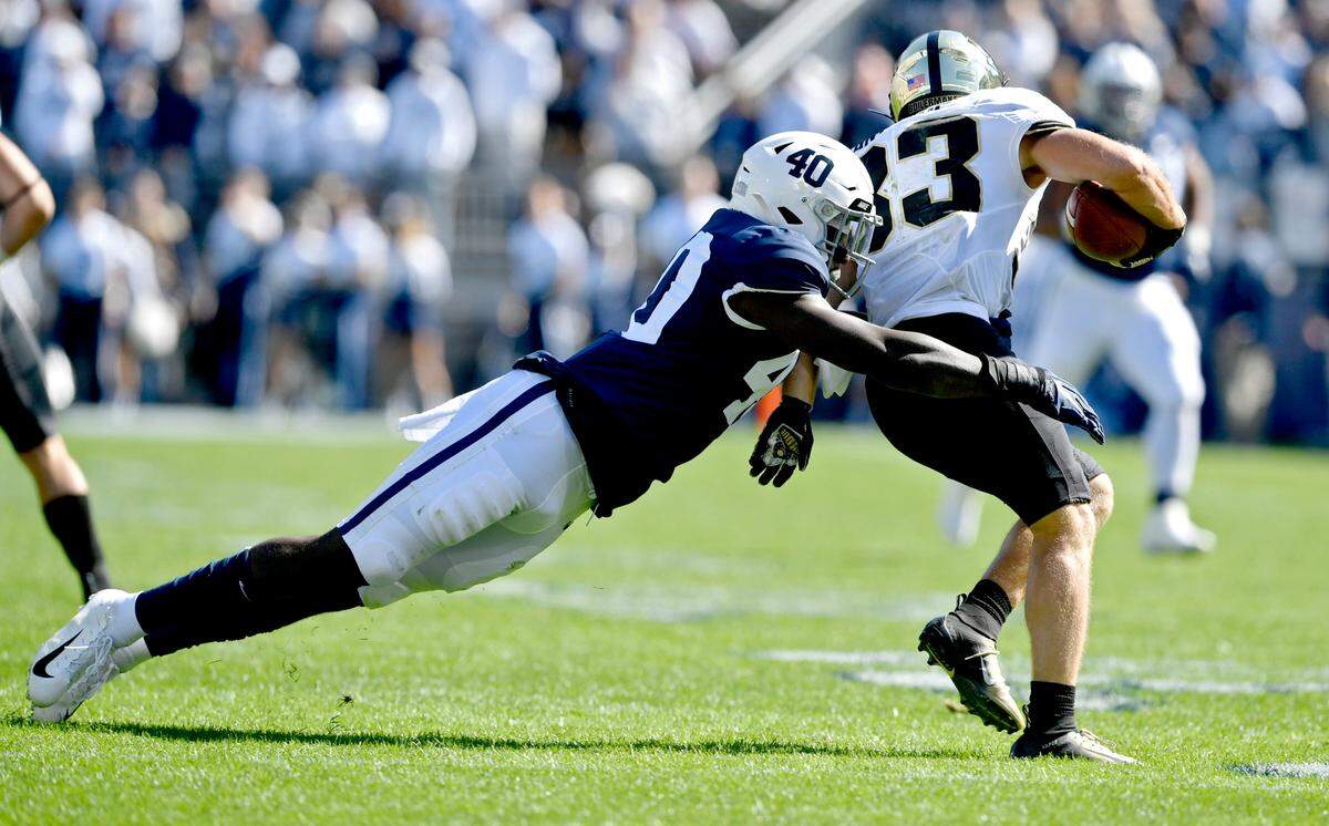 Jesse Luketa, pictured diving for Purdue wide receiver Jackson Anthrop in 2019, is expected to rotate at both linebacker and defensive end this season.