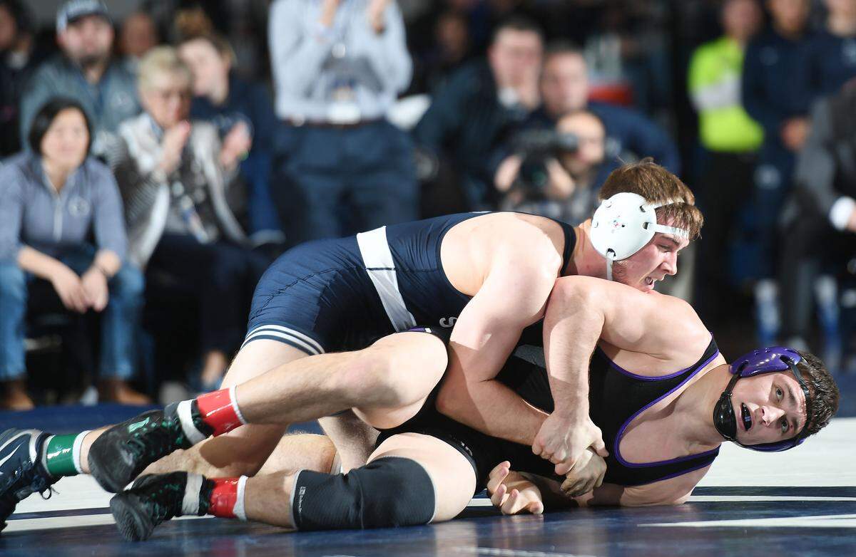 Penn State’s freshman Creighton Edsell takes down Northwestern’s Jack Jessen during Sunday’s match at Rec. Hall. Edsell defeated Jessen, 4-1. Penn State defeated Northwestern 30-9. (For the CDT/Steve Manuel)