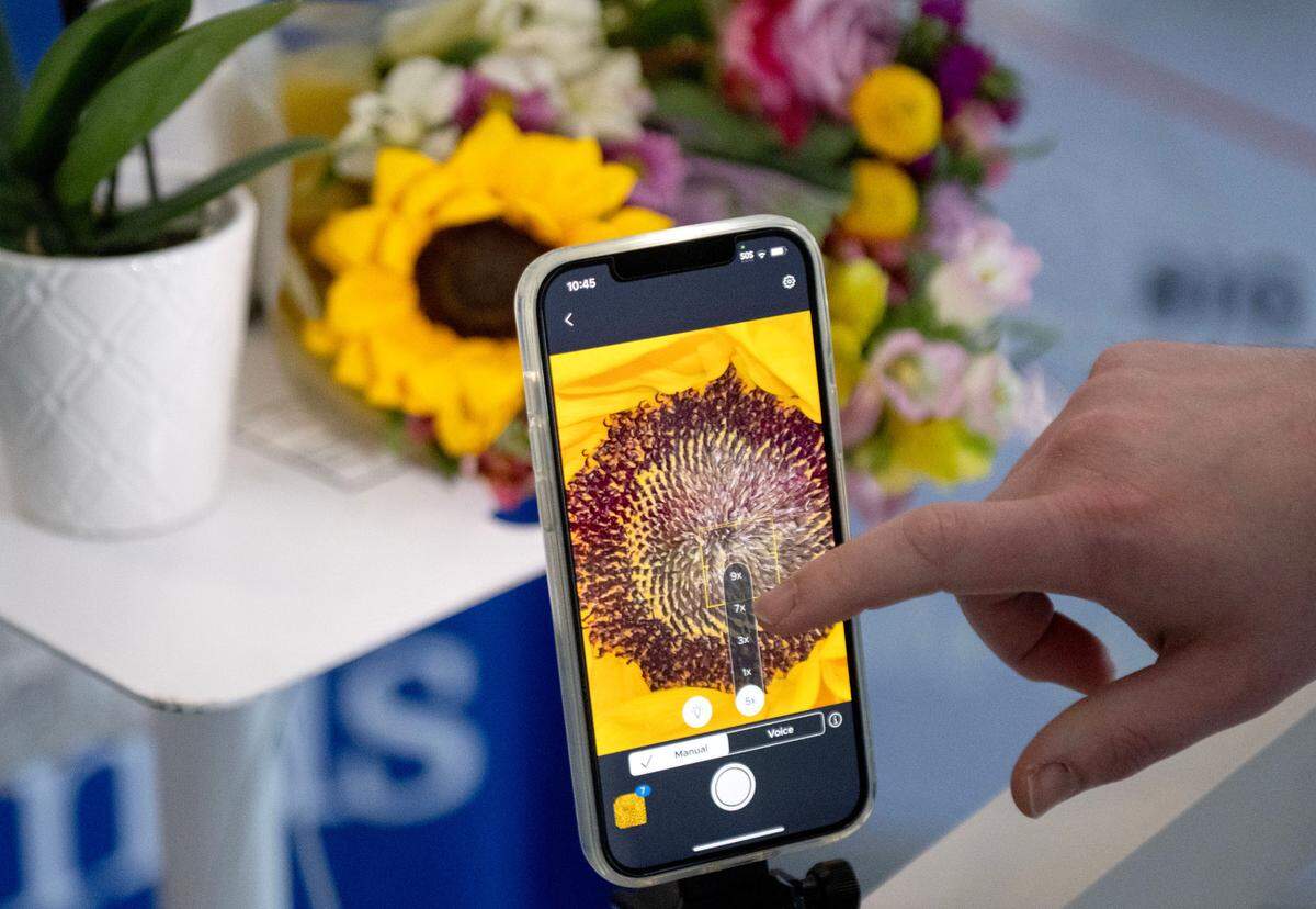 Ian Spears shows how the Sexual Assault Forensic Examination Telehealth (SAFE-T) System works with the magnification and voice commands by demonstrating on a bouquet of flowers on Tuesday, May 27, 2025.