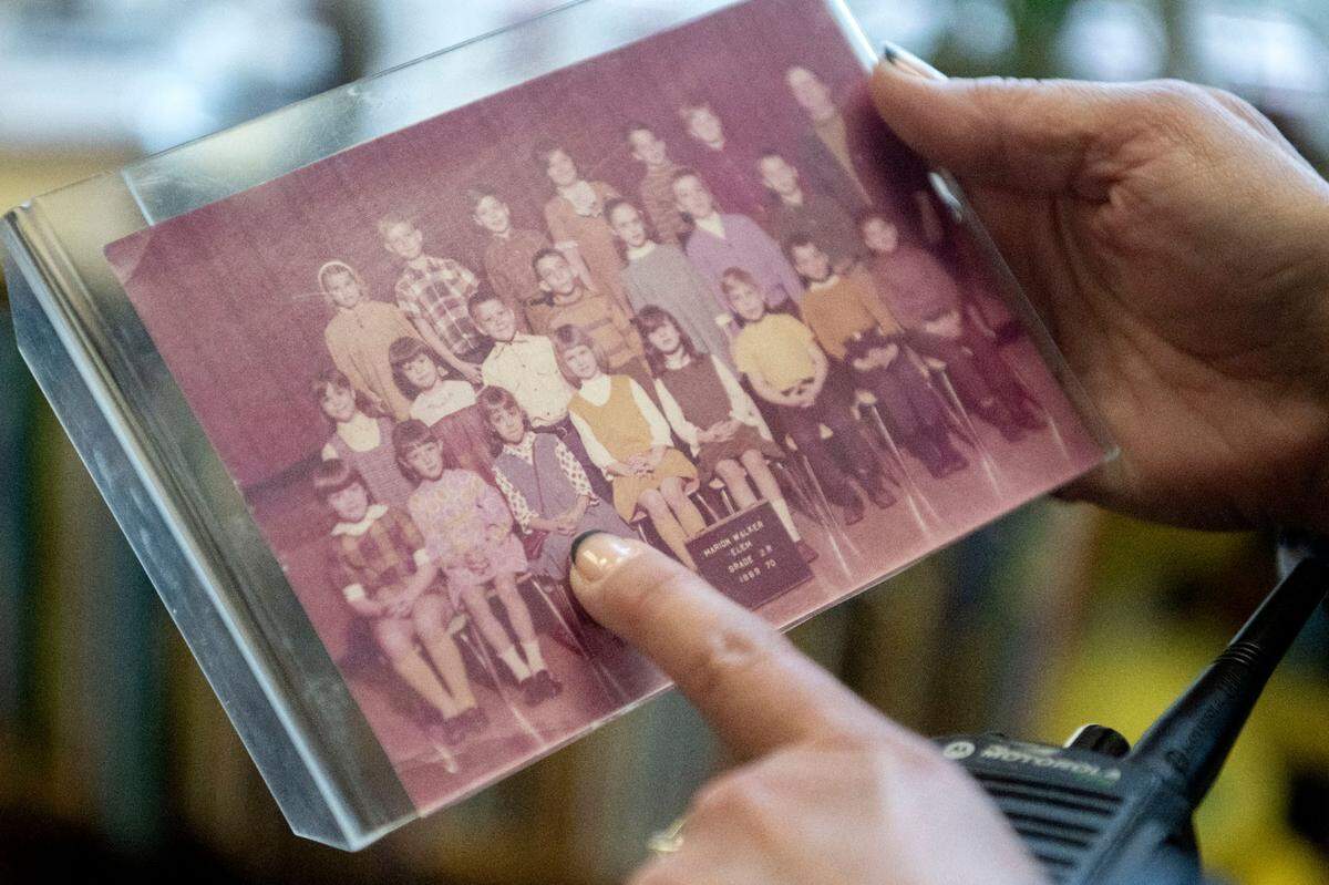Marion Walker Elementary school principal Karen Krisch points herself out in her second grade photos from the same elementary school that she keeps in her office.