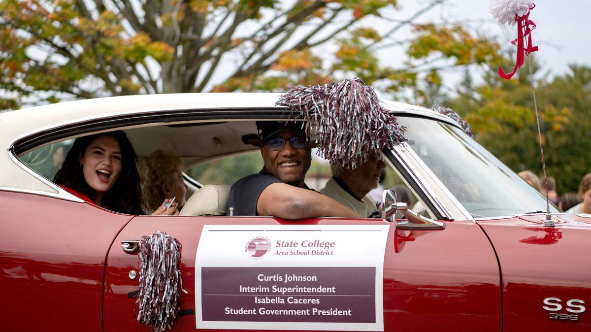 State College Area interim superintendent Curtis Johnson laughs as he rides in the State College homecoming parade on Oct. 6. Johnson was appointed superintendent on Monday night.