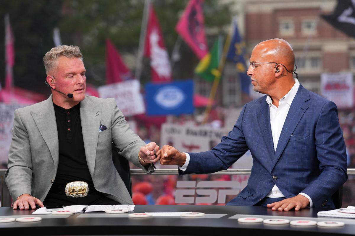 Former Penn State coach James Franklin fist-bumps ESPN analyst Pat McAfee during a segment on ESPN’s College GameDay on Saturday, Oct. 18, 2025, in Athens, Georgia, ahead of the Ole Miss-Georgia game.