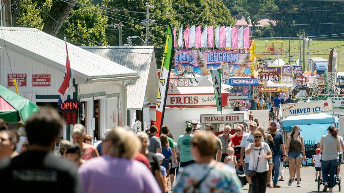 Visitors walk along Sharer Avenue on the first day of the Centre County Grange Fair on Friday, Aug. 19, 2022. The fair has started to announced grandstand acts for the 2023 event.