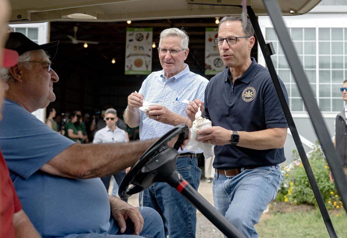 Pennsylvania Governor Josh Shapiro eats a dish of Berkey Creamery’s cookie dough ice cream as he chats with visitors at Penn State’s Ag Progress Days on Wednesday, Aug. 13, 2025.  