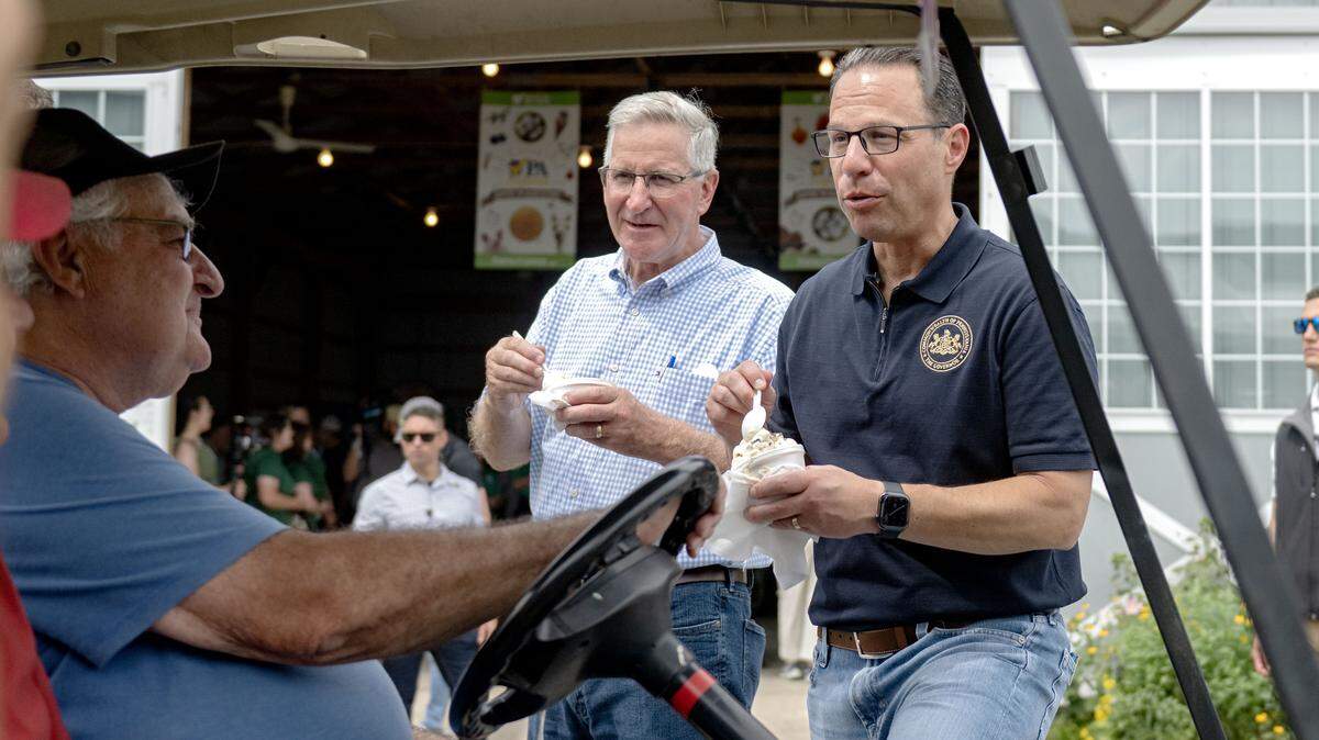 Pennsylvania Governor Josh Shapiro eats a dish of Berkey Creamery’s cookie dough ice cream as he chats with visitors at Penn State’s Ag Progress Days on Wednesday, Aug. 13, 2025.