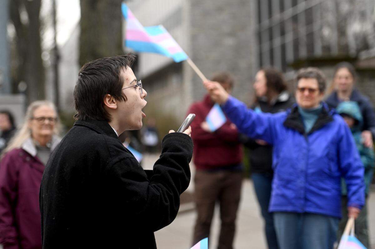 Nico Geier reads his poem “I am a Boy” during the Transgender Day of Visibility gathering hosted by the Centre LGBTQA Support Network at the Allen Street gates on Friday, March 31, 2023.