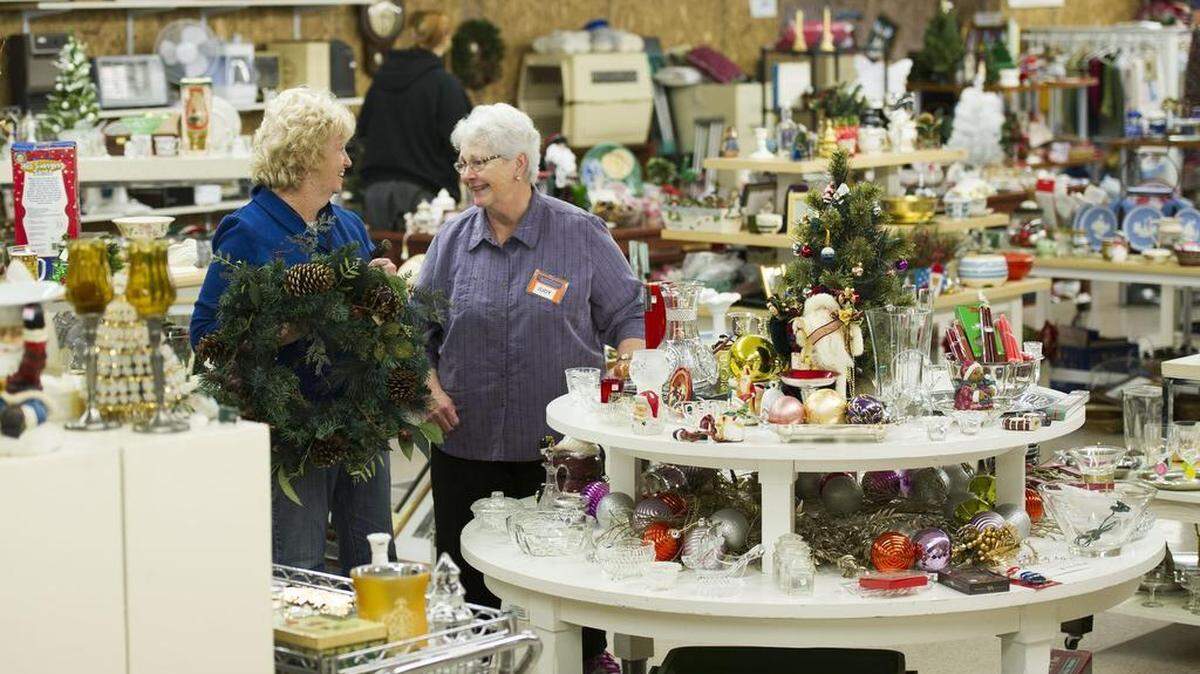 Patty Condo, left, and Judy Clogg, both volunteers, arrange items at the new CentrePeace building on Monday.
