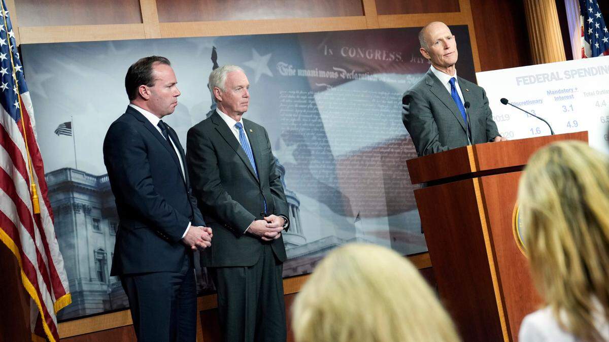 Sen. Rick Scott, R-Fla., right, Sen. Ron Johnson, R-Wis., center, and Sen. Mike Lee, R-Utah, speak Wednesday during a news conference on spending on Capitol Hill in Washington.
