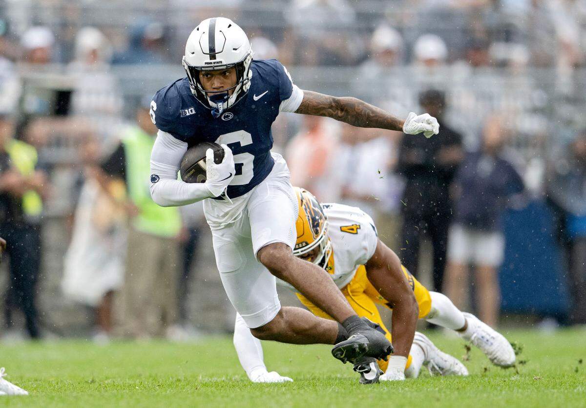 Penn State wide receiver Tre Wallace cuts down the field with the ball from a Kent State defender during the first quarter of the game on Saturday, Sept. 21, 2024 at Beaver Stadium.