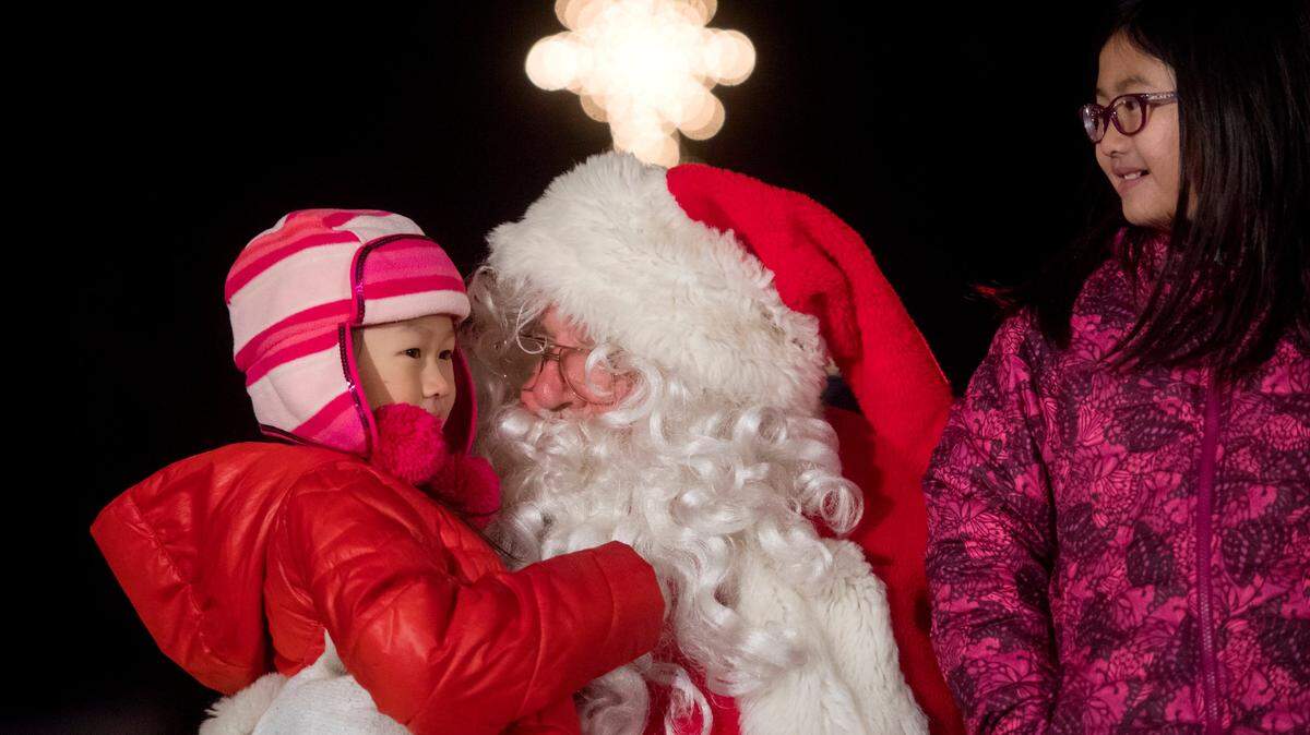 Santa talks to youngsters during the downtown State College tree lighting ceremony in November 2017.