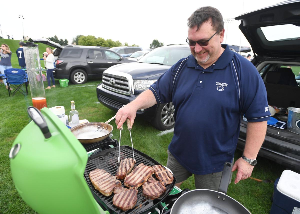 Scott Phillips grills steak and eggs before the Penn State vs. Kent State game Saturday, Sept. 15, 2018 at Beaver Stadium.