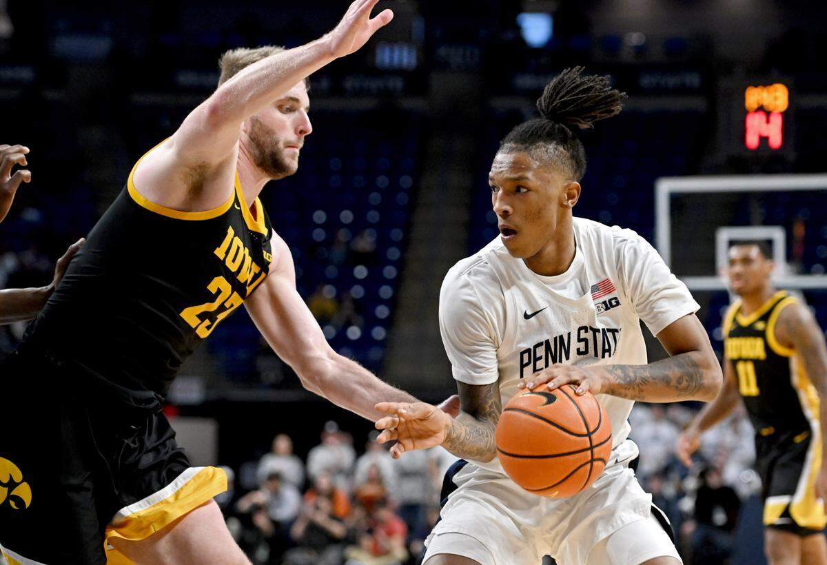 Penn State’s Nick Kern Jr. cuts down the court with the ball around Iowa’s Ben Krikke during the game on Wednesday, Feb. 8, 2024. Penn State won, 89-79.