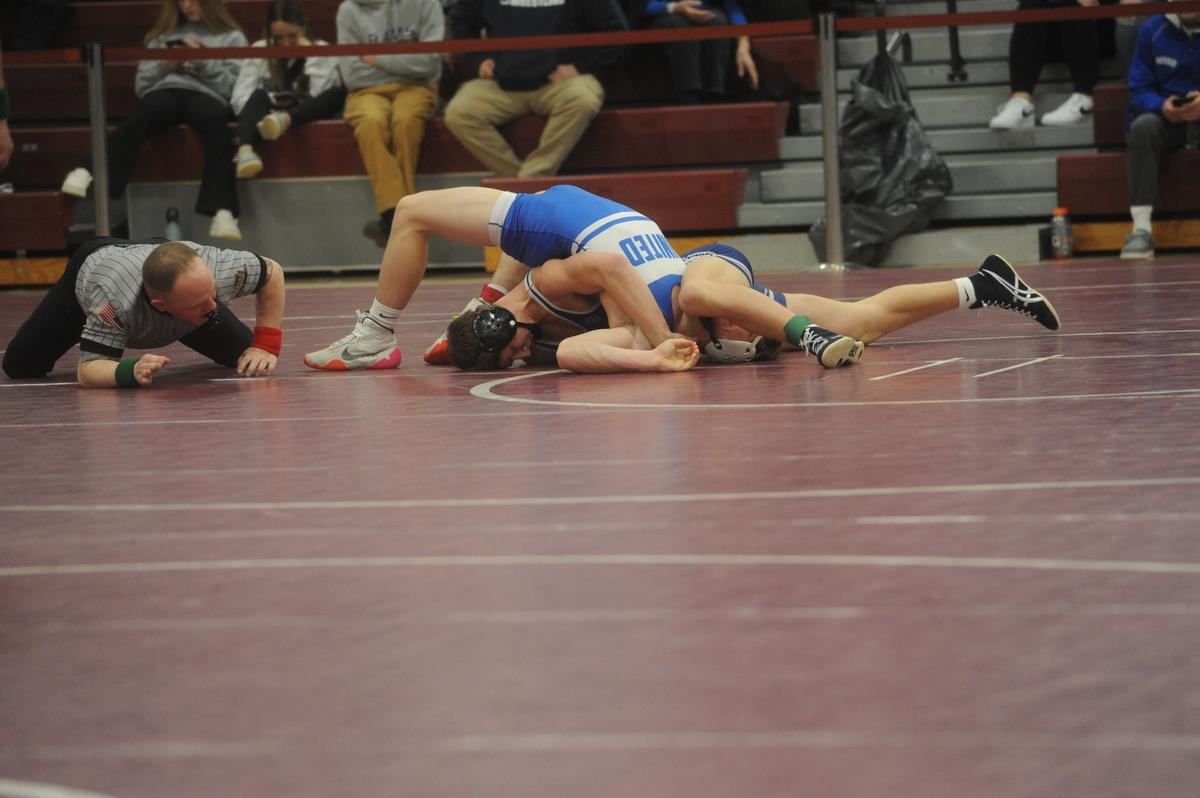 Penns Valley’s Ty Watson aims to pin United’s Caden McCully in their 152-pound quarterfinals match of the District 6 Class 2A Championships on Friday, Feb. 17, 2023 in Altoona. Watson did get the fall in 4:19.