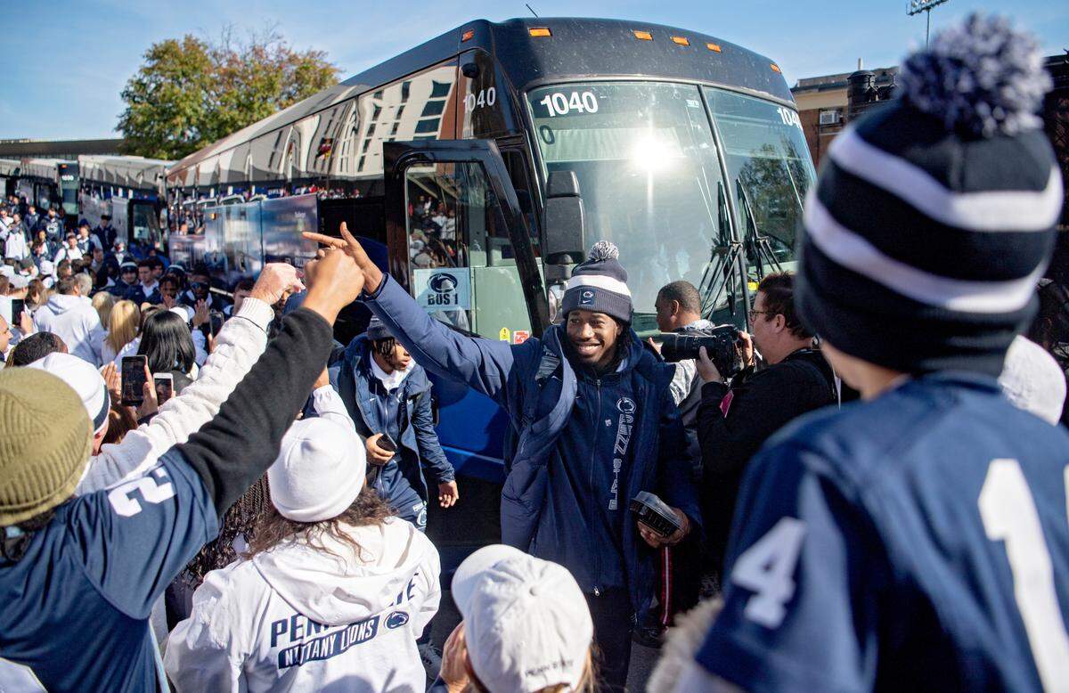 Penn State cornerback Joey Porter Jr. high fives fans as he and the team arrive at Capital One Field at Maryland Stadium on Saturday, Nov. 6, 2021.