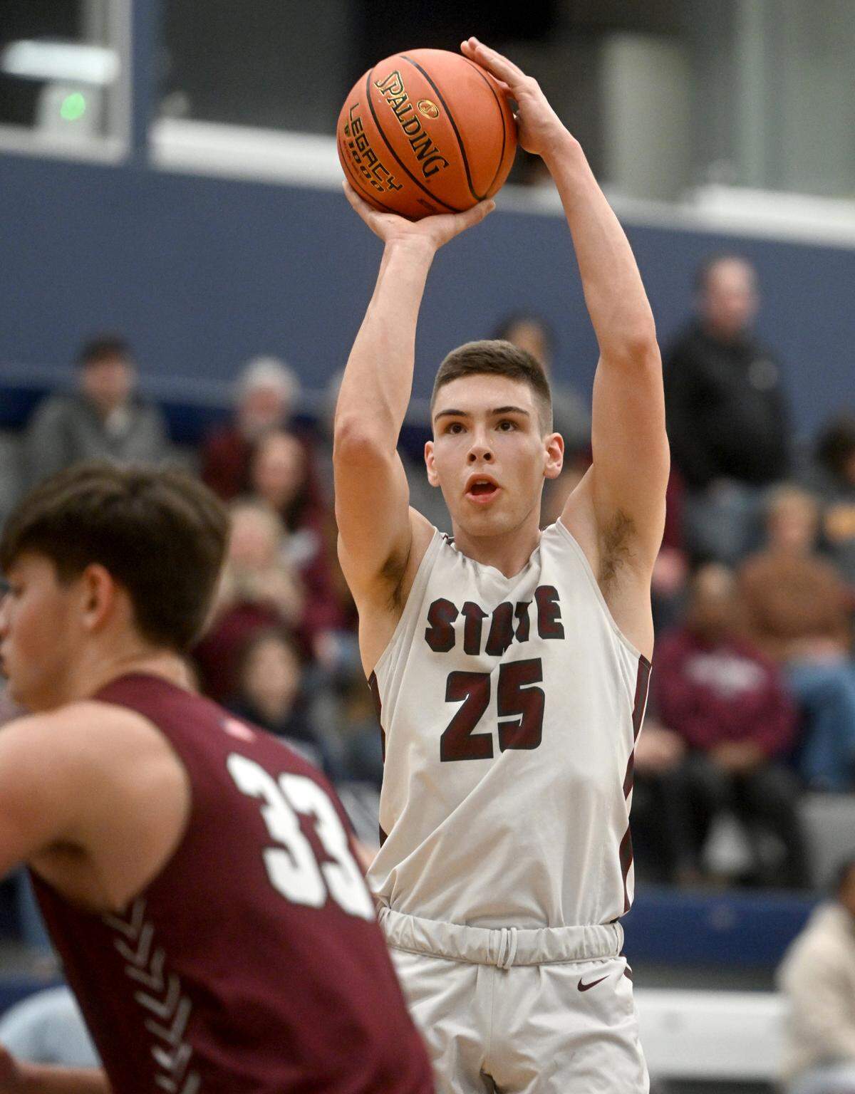 State College’s Isaac Dye makes a shot over Altoona defenders during the District 6 6A championship game at Mount Aloysius College on Friday, Feb. 24, 2023.