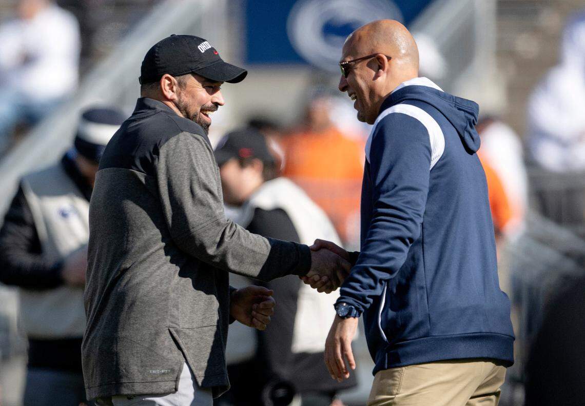 Ohio State coach Ryan Day and Penn State coach James Franklin shake hands and chat before the game Beaver Stadium on Saturday, Oct. 29, 2022.