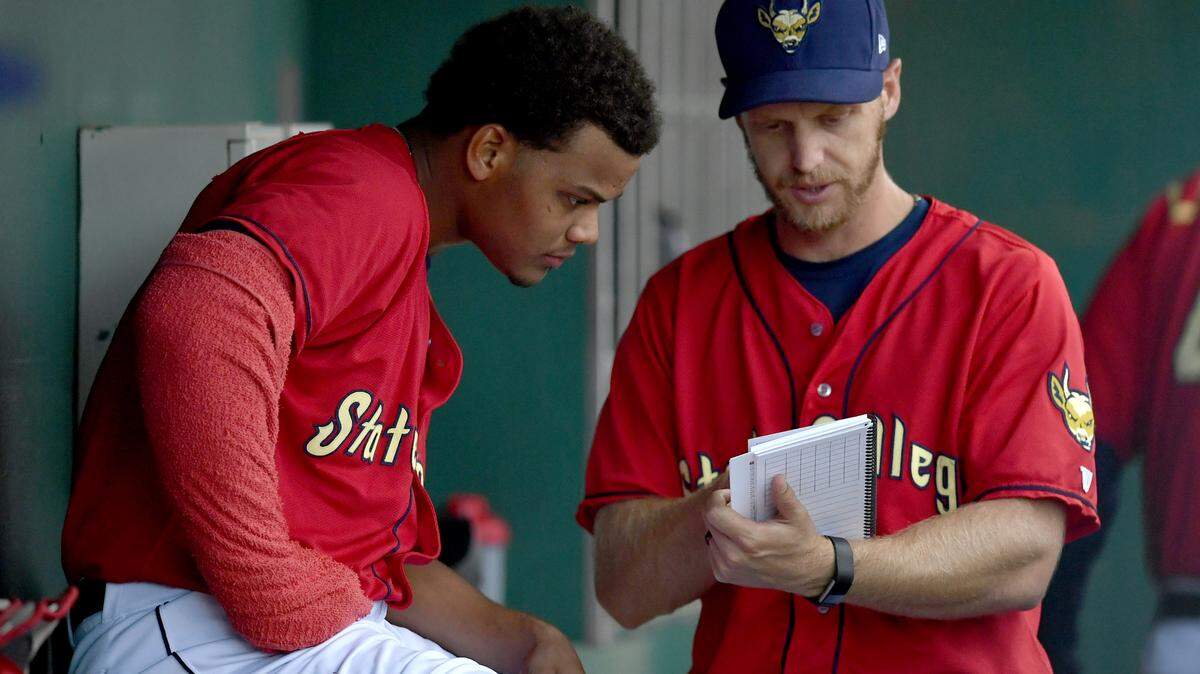 State College Spikes' pitching coach Adrian Martin talks to starting pitcher Winston Nicacio between innings during the Tuesday, June 26, 2018 game at Medlar Field. 
