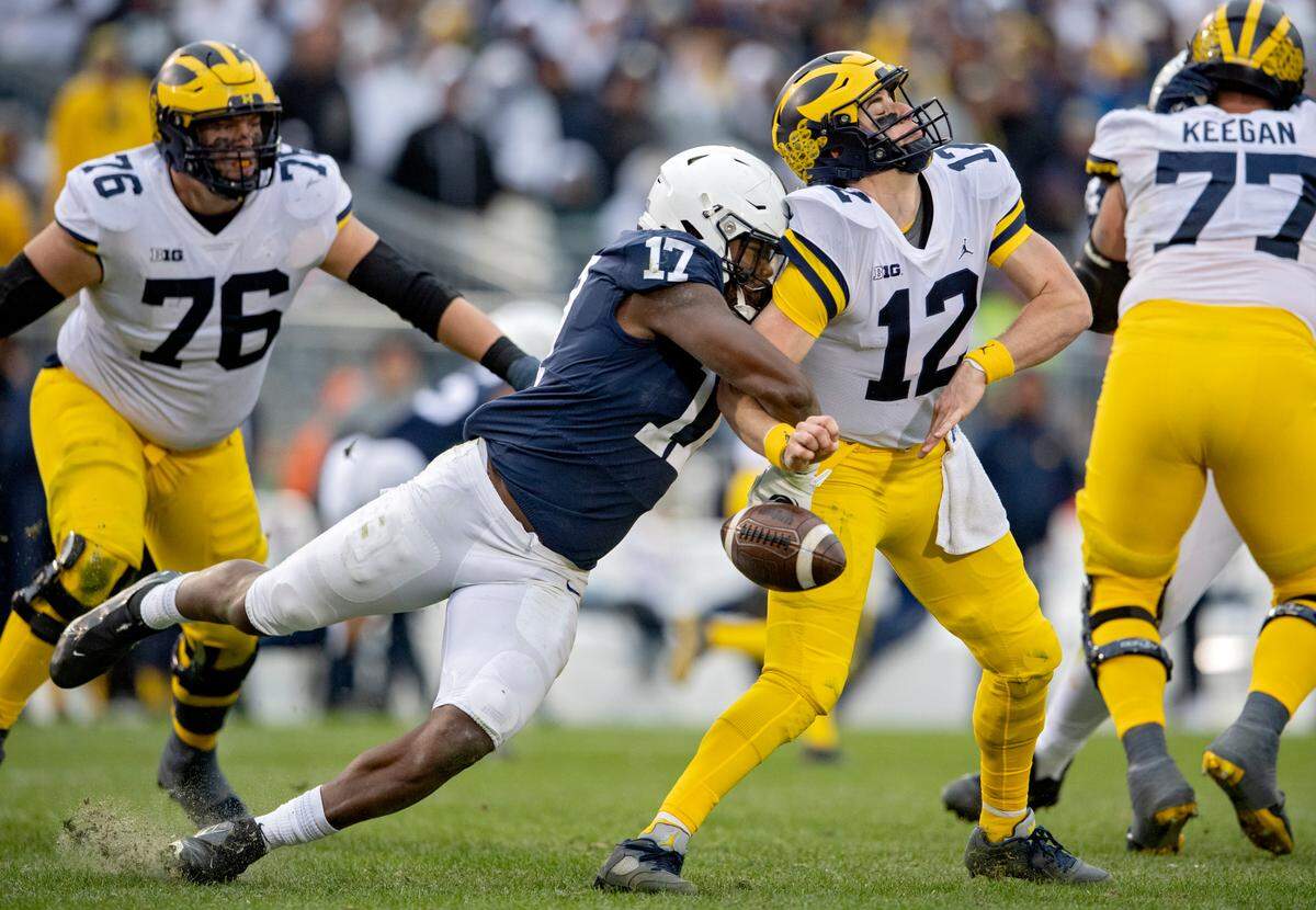 Penn State defensive end Arnold Ebiketie sacks Michigan quarterback Cade McNamara, making him drop the ball during the game on Saturday, Nov. 13, 2021. Penn State recovered the ball and scored a touchdown.