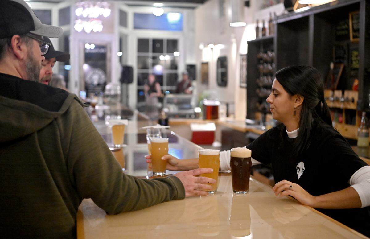 Bartender Celina Rosaro serves a round of drinks to patrons at The Dead Canary Brewing Company in Philipsburg on Thursday, Oct. 19, 2023.