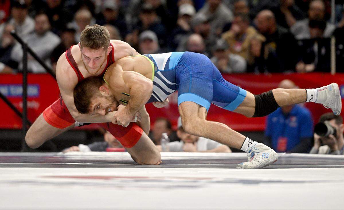 Nick Lee and Zain Retherford wrestle in their first bout of the 65 kg challenge round U.S. Olympic Team Trials at the Bryce Jordan Center on Saturday, April 20, 2024. Retherford won by decision, 2-1.