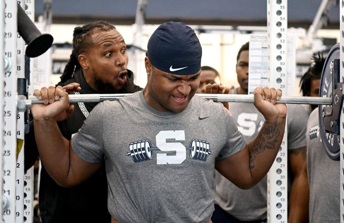 Penn State defensive tackle Xavier Gilliam is cheered on as he lifts during a winter workout session on Thursday, Feb. 29, 2024.