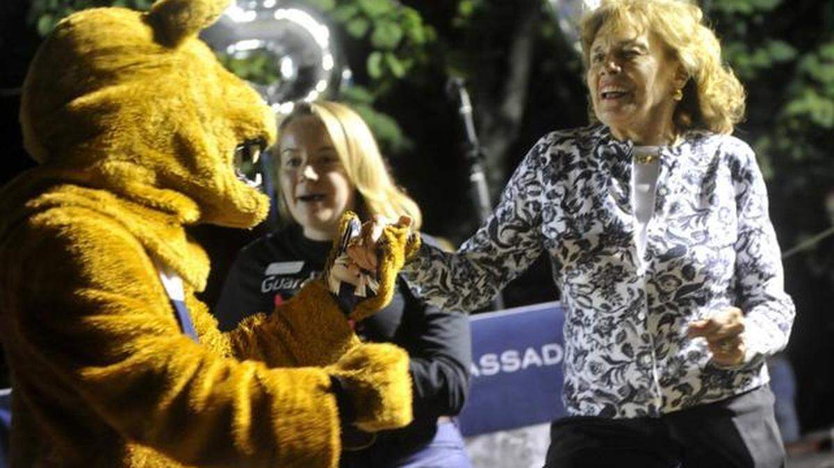 Sue Paterno dances with the Nittany Lion during the Guard the Lion Shrine event on Friday, Sept. 26, 2014.