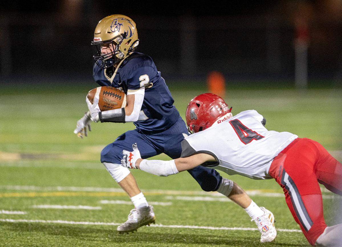 Bald Eagle Area’s Kahale Burns runs from a Purchase Line defender during the game on Friday, Oct. 28, 2022.