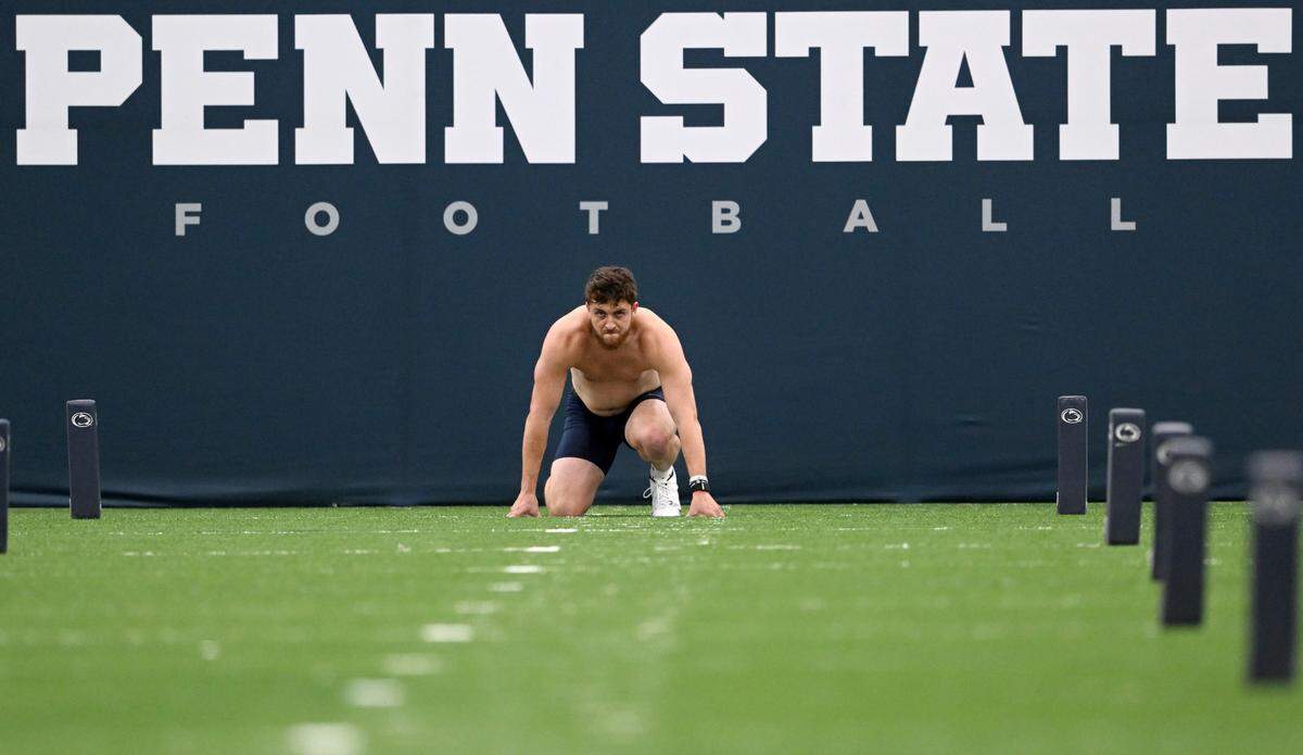 Quarterback Sean Clifford takes his shirt off and prepares to run the 40 yard dash for the second time during Penn State football’s Pro Day on Friday, March 24, 2023.