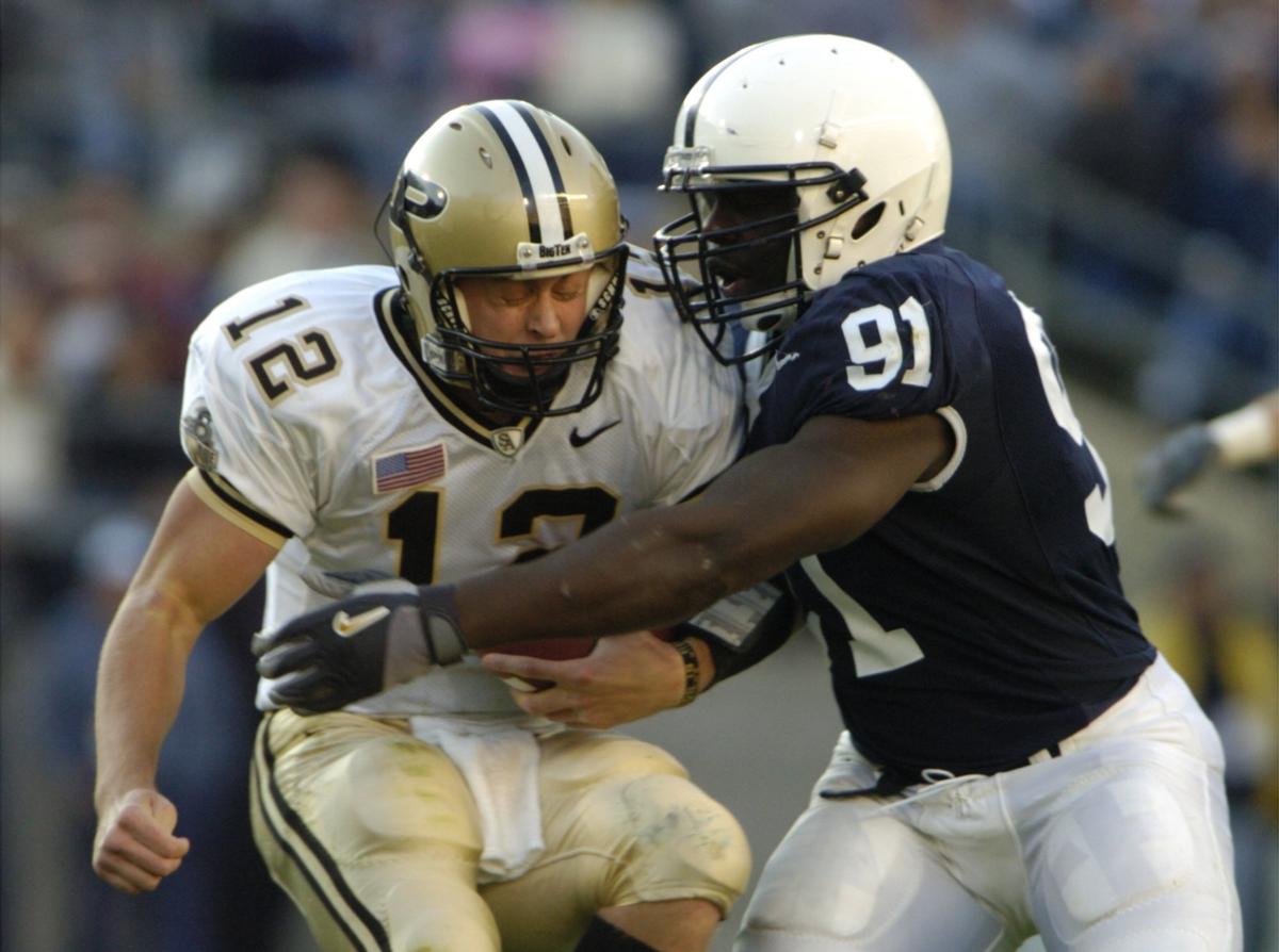 Tamba Hali sacks Purdue quarterback #12 Curtis Painter in the first half of a game in 2005. CDT photo/Nabil K.  Mark