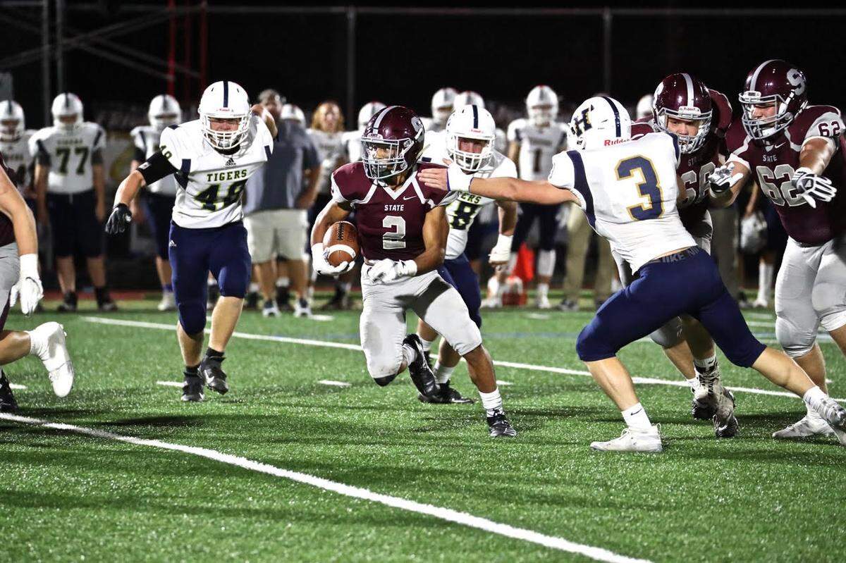 State College’s Dresyn Green runs down the field against Hollidaysburg Friday at the South Track.