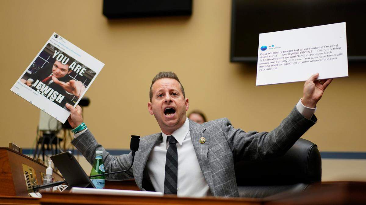 Rep. Jared Moskowitz, D-Fla., holds up tweets during a House Committee on Oversight and Accountability hearing Wednesday on Capitol Hill.