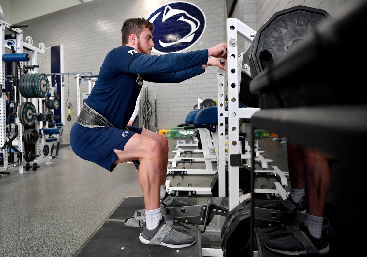 Penn State quarterback Sean Clifford squats during a weightlifting session on Wednesday, March 4, 2020.