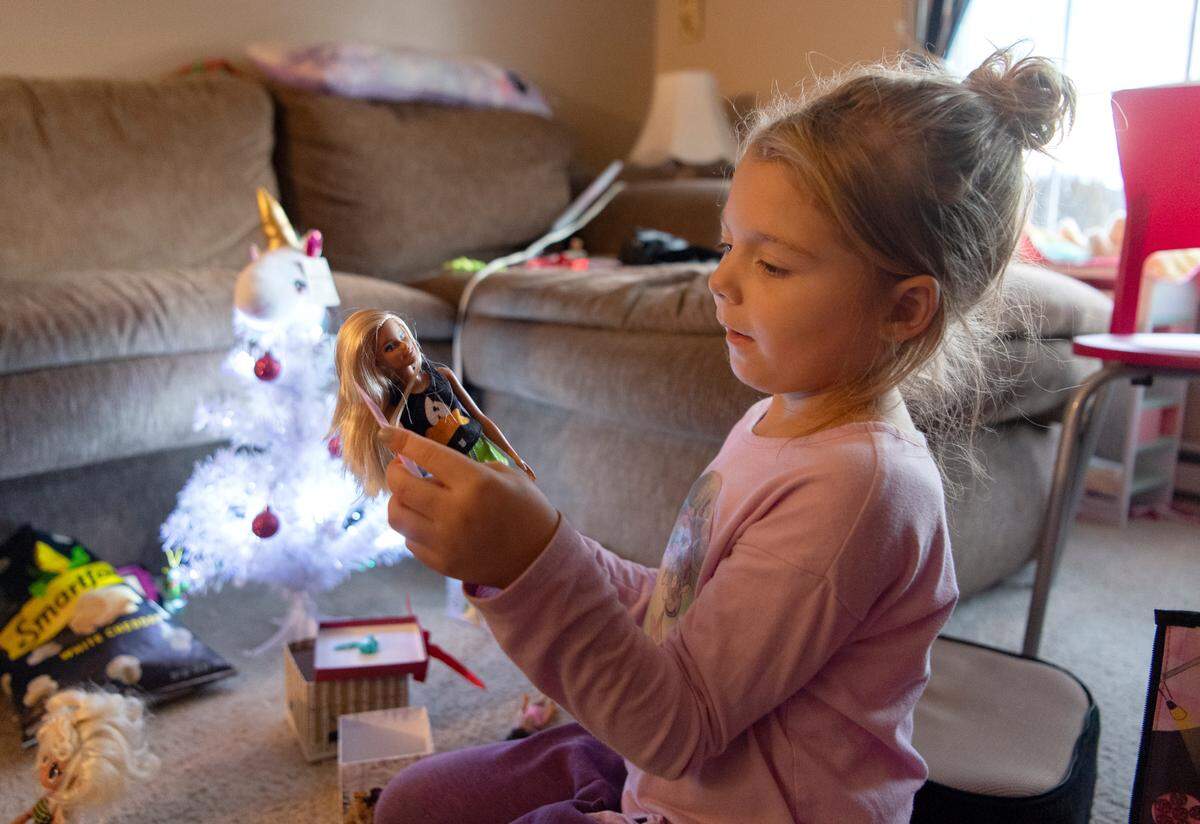 Kennedy Wilson plays with her Barbie dolls on Monday.