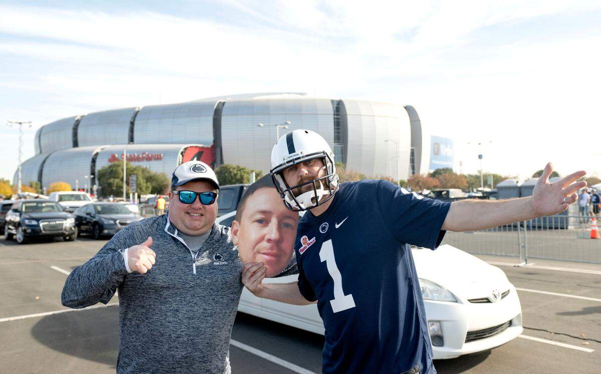 Penn State fans Casey Brown and Pete Davis pose for a photo outside of State Farm Stadium on Tuesday, Dec. 31, 2024.
