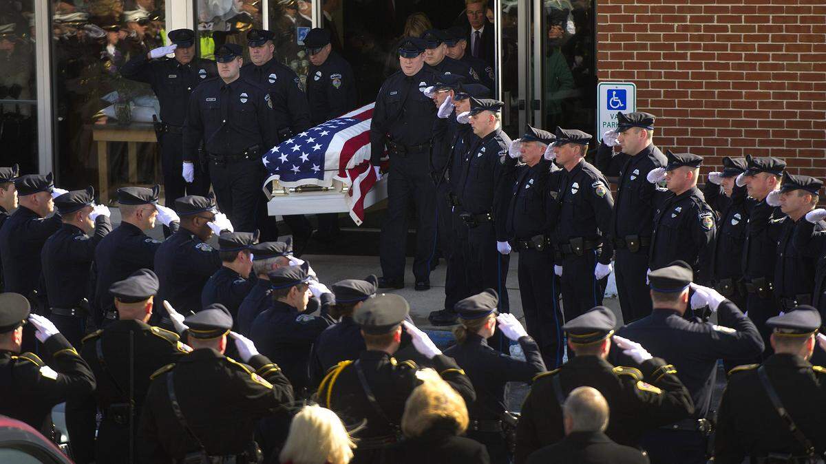Officers carry the casket of State College Police Officer Bob Bradley after his funeral at First Baptist Church in Bellefonte on Friday, Feb. 13, 2015.