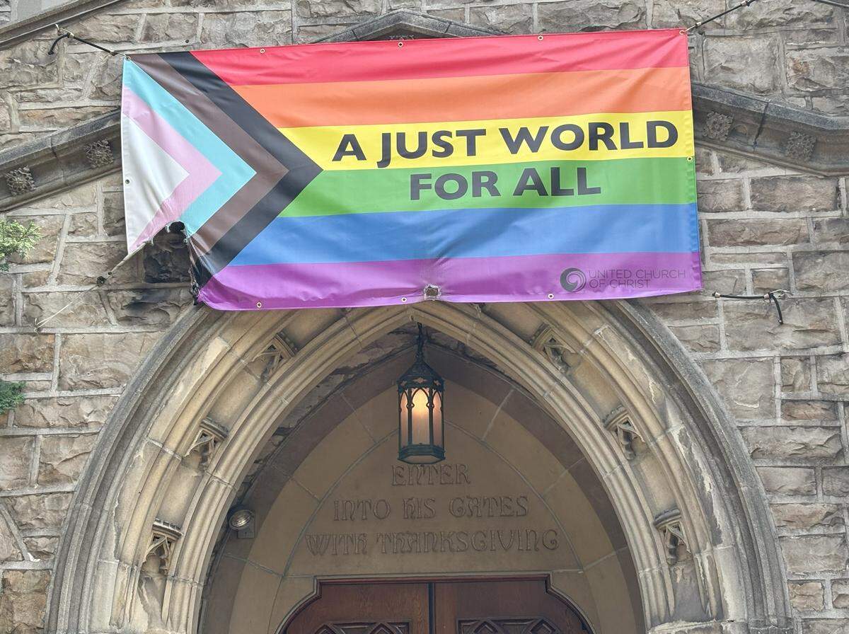 Faith UCC’s Pride flag hanging above its entrance was burned Friday, with damage still visible in the lower left-hand corner Saturday.