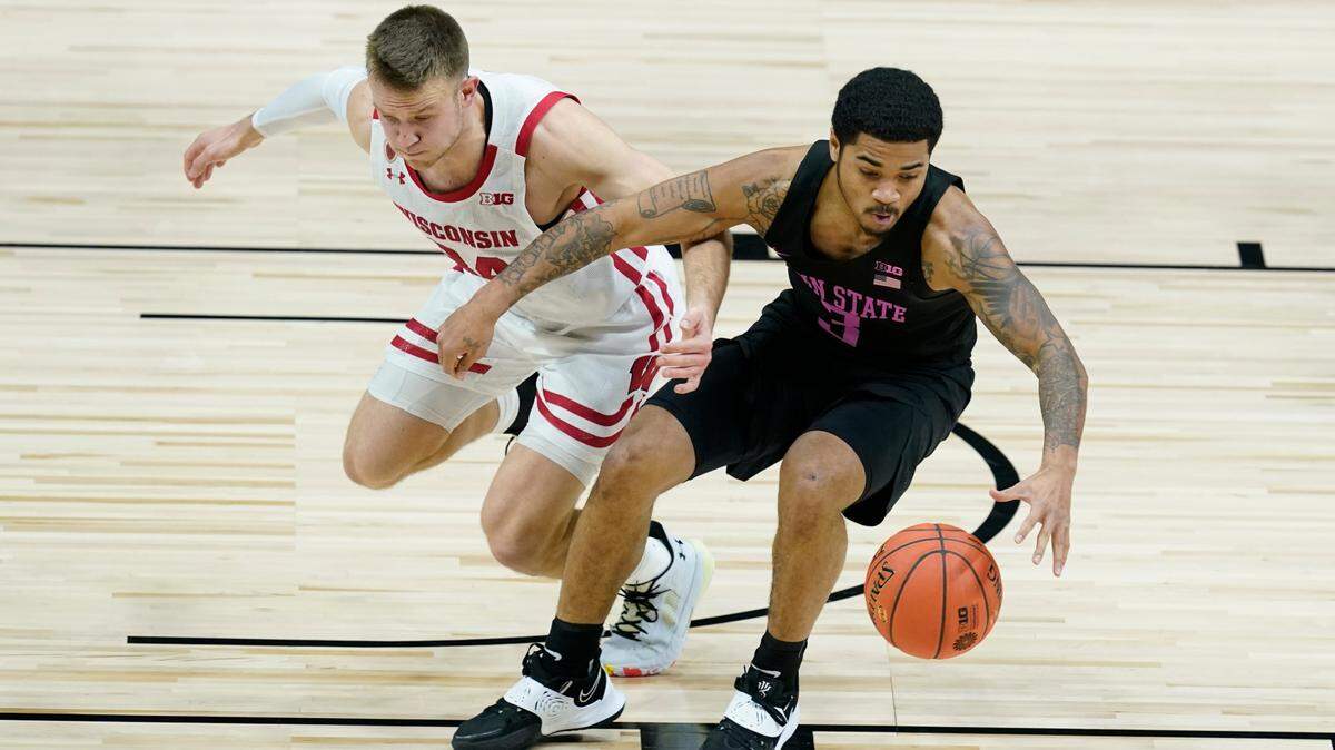 Penn State’s Sam Sessoms (3) chases down a loose ball against Wisconsin’s Brad Davison (34) during the first half of an NCAA college basketball game at the Big Ten Conference tournament, Thursday, March 11, 2021, in Indianapolis.