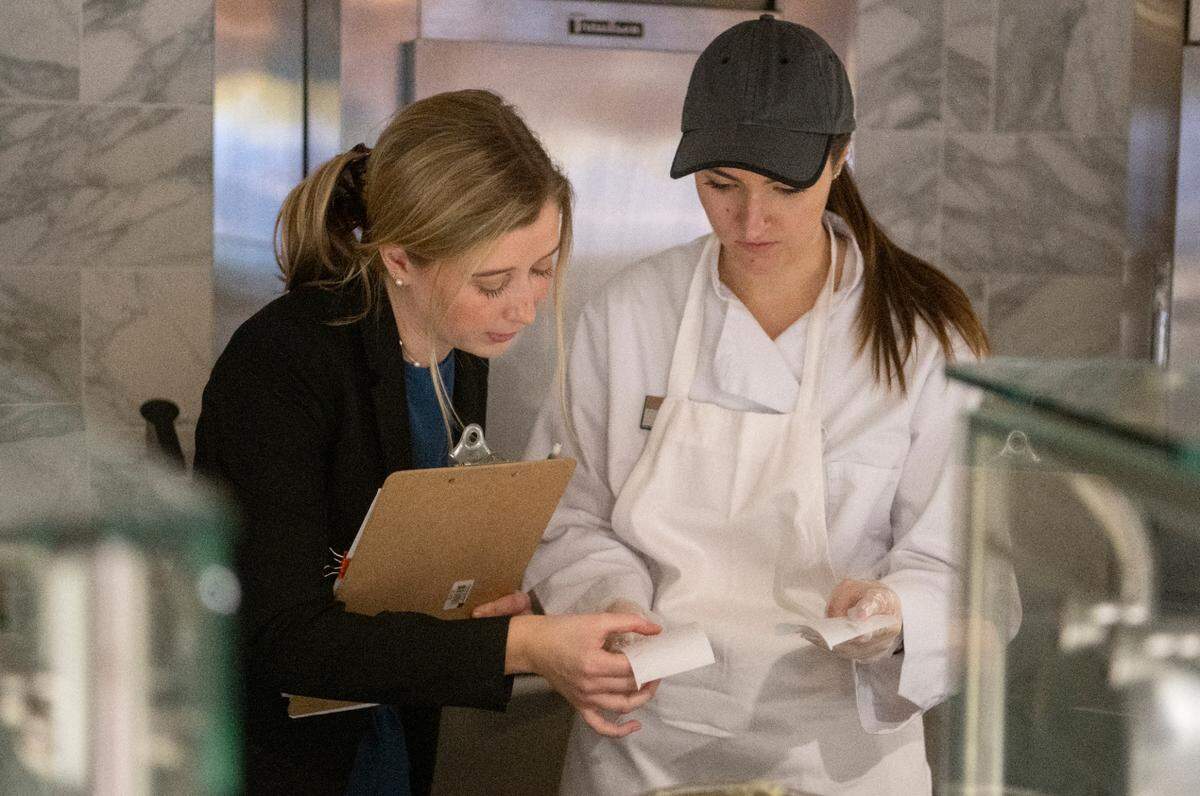 Chloe Kehayas, the general manager for the Amalfi Dream themed dinner at Cafe Laura, looks over an order slip on Wednesday, March 1, 2023.