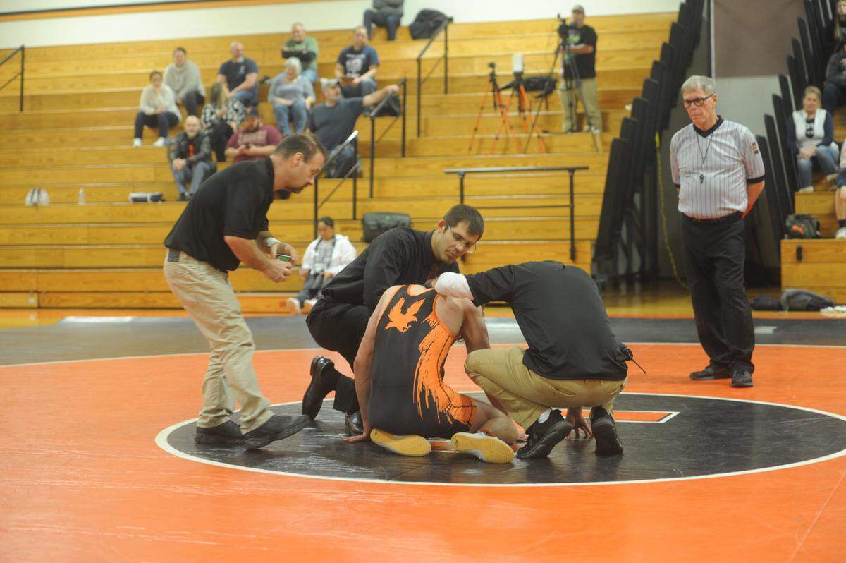 Tyrone coach Quentin Wright checks on Zach Lash during his 189-pound bout during the Golden Eagles’ 39-31 win on Tuesday. Wright, who wrestled at Penn State and Bald Eagle Area, is in his first year of coaching.